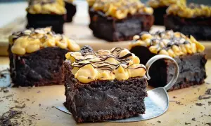 Saftige schoko brownies mit cremiger Topping und Schokodrizzle, verlockend dekoriert mit Schokostreuseln.