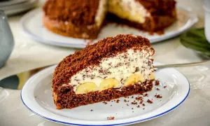 Ein Stück saftiger Maulwurfkuchen mit Bananen und Sahne. Dieses Maulwurfkuchen Rezept ist ein Genuss!