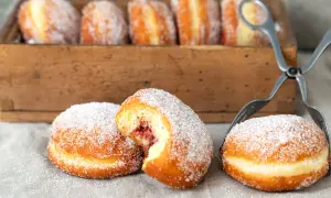 Frisch gebackene Berliner, mit Zucker bestreut, warten auf ihre Füllung. Ein köstliches berliner rezept.