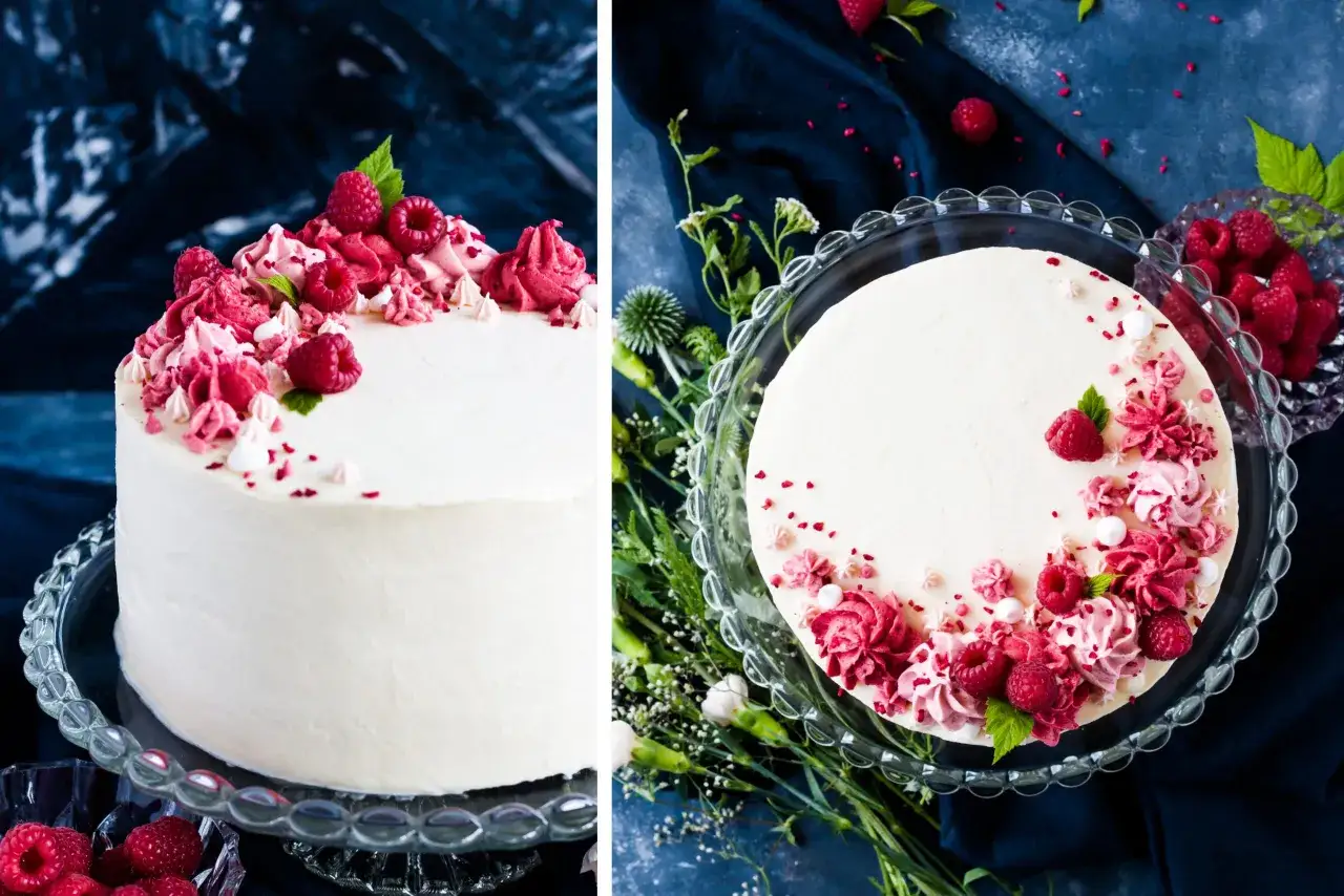 Eine weiße Torte, verziert mit Himbeeren und rosa Buttercreme-Rosetten. Diese Himbeer Torte ist ein Fest für die Augen.